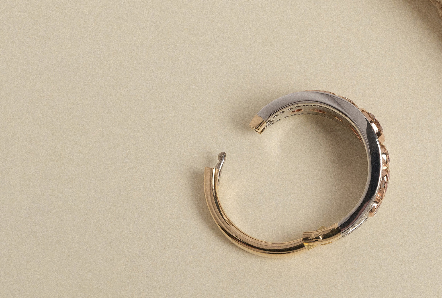 Yellow, white and rose gold hinged ring set with natural white diamonds.