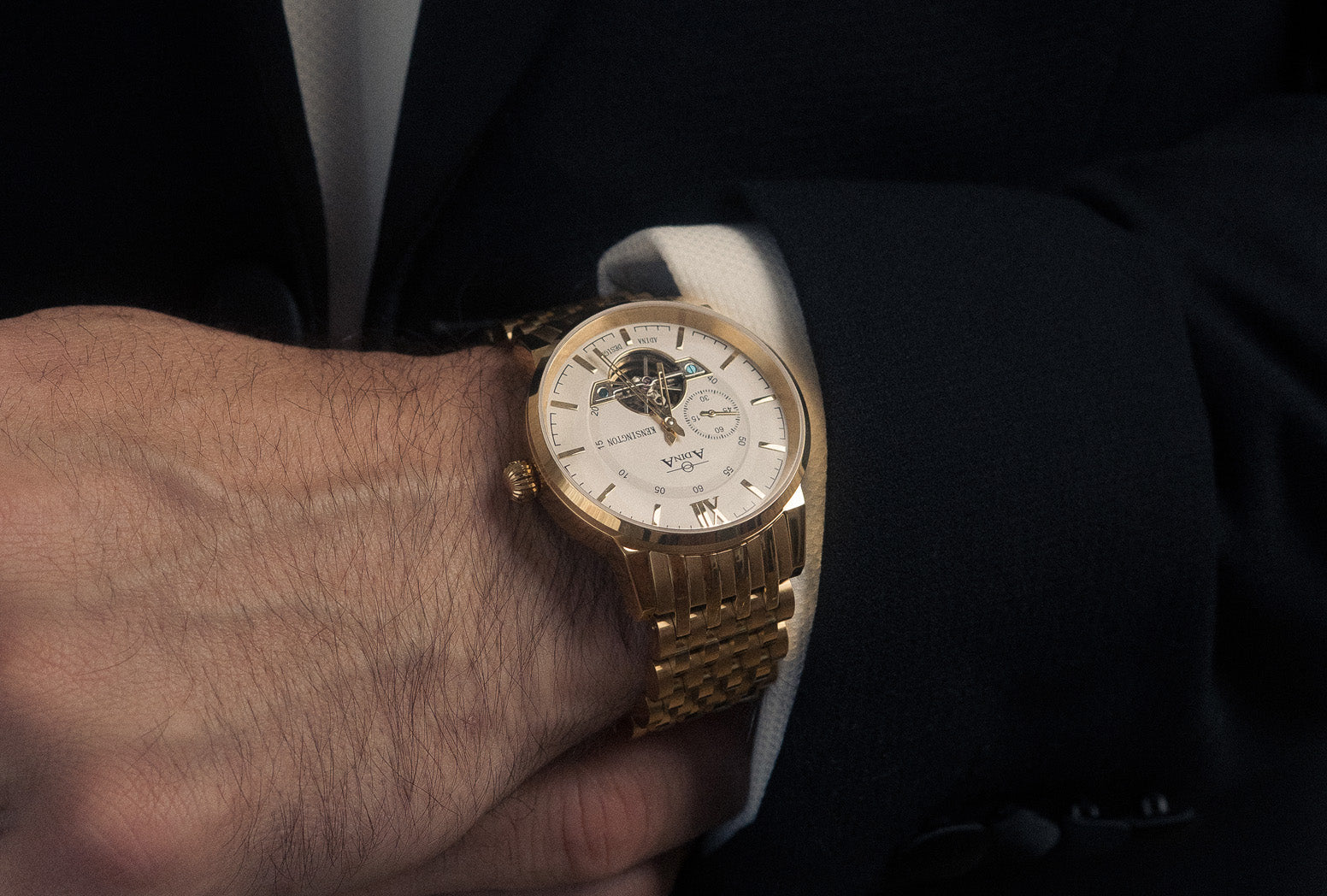 Mens gold Adina watch on mens wrist.