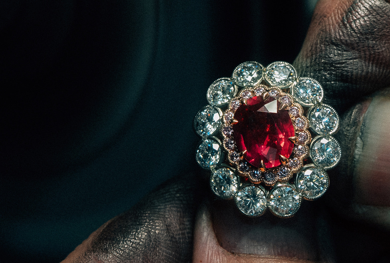 18k yellow white and rose gold halo ring with oval cut natural ruby, round brilliant cut Australian pink diamonds and round brilliant cut natural white diamonds.