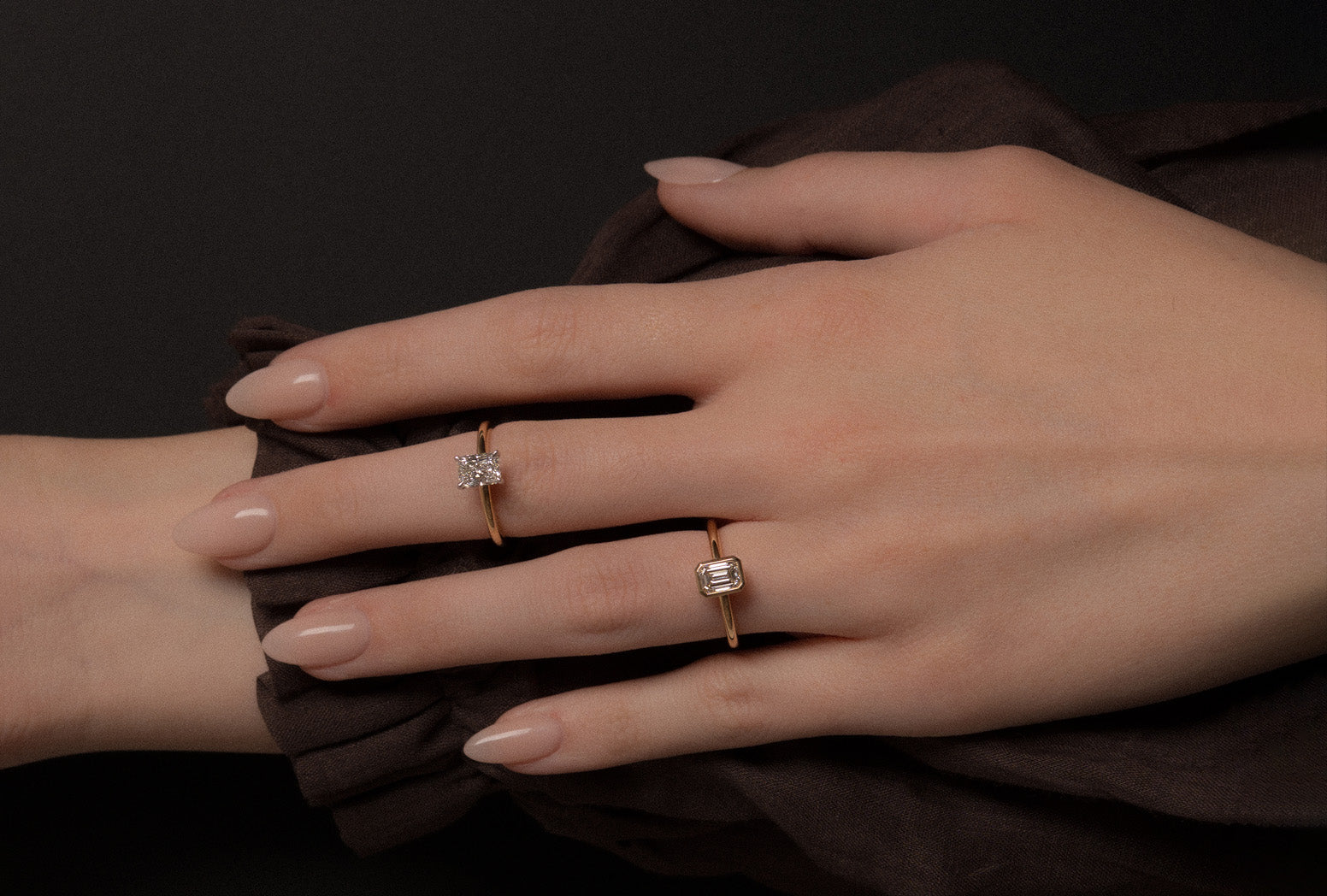 Modelled photo of yellow and white gold solitaire rings with emerald and radiant cut natural white diamonds.