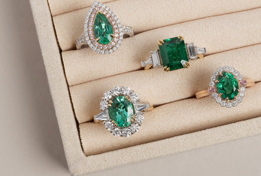 Multiple yellow, white and rose gold rings set with natural emerald gemstones, and natural white diamonds.