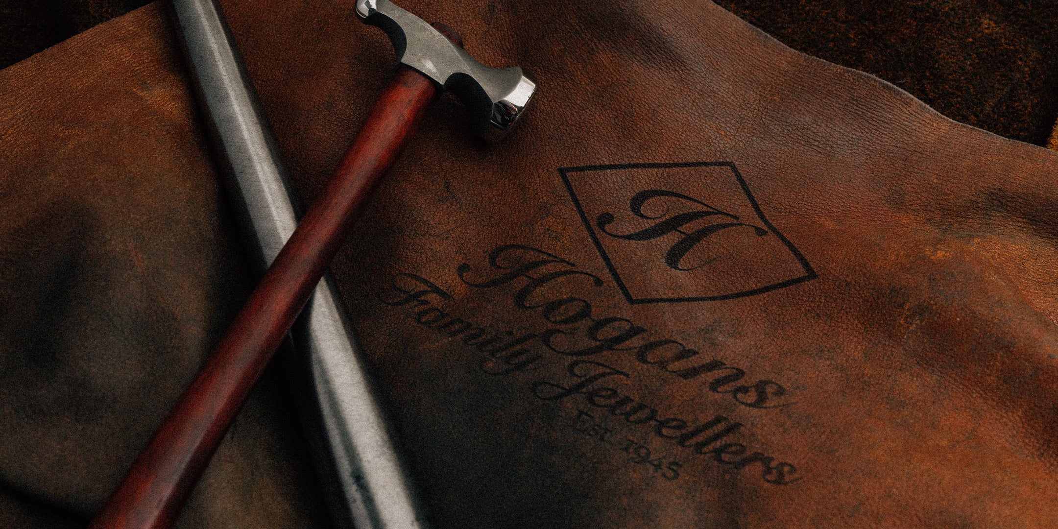 Men in suit with golden Adina watch on wrist.