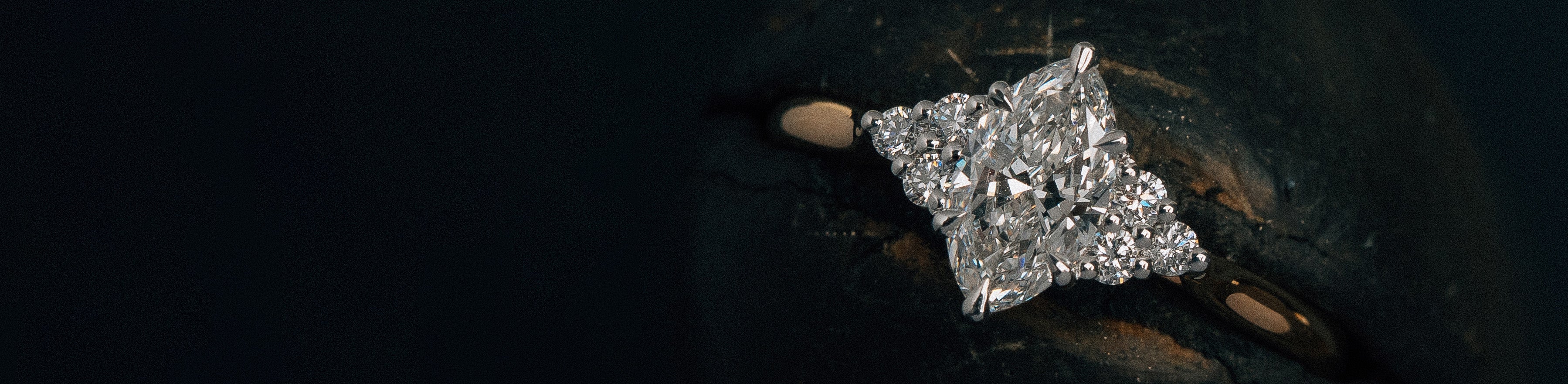 Yellow and white gold natural marquise cut and round brilliant cut diamond cluster ring.
