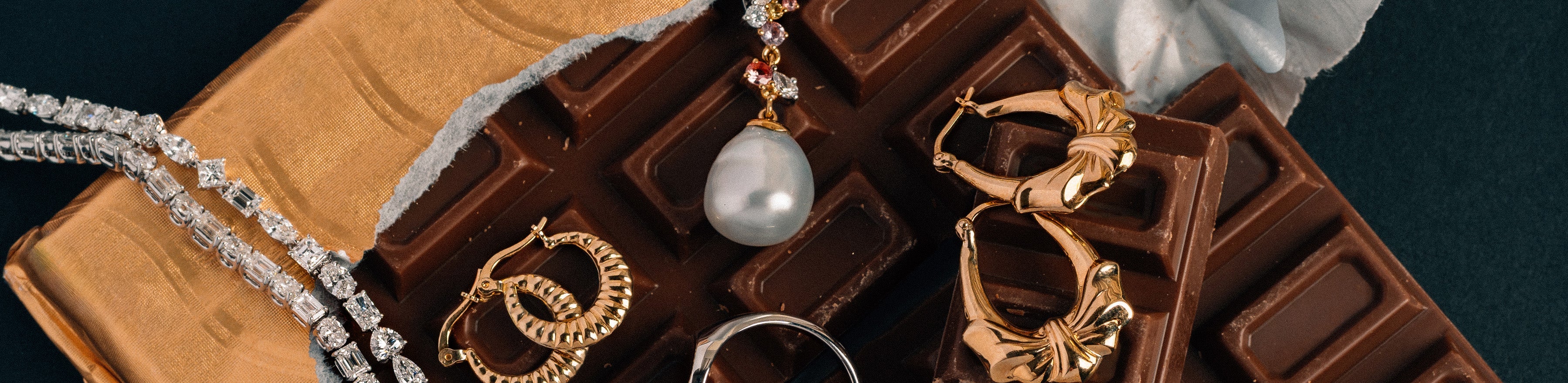Range of ready to wear jewellery pieces displayed on a block of chocolate.