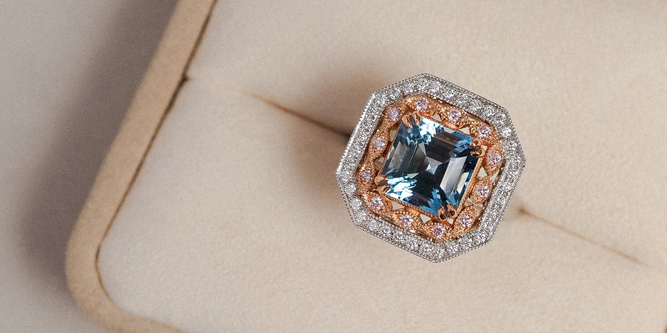 Art deco style aquamarine and diamond dress ring in beige ring box.
