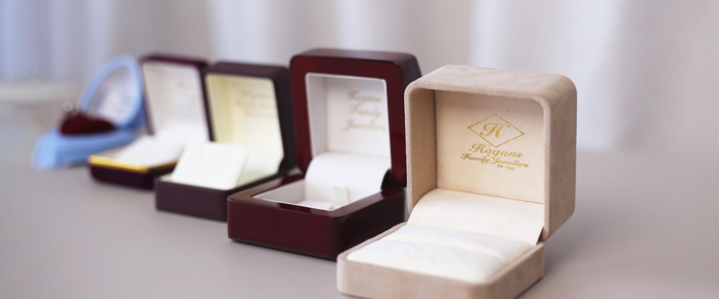 Line up of open jewellery boxes from Hogans Family Jewellers.