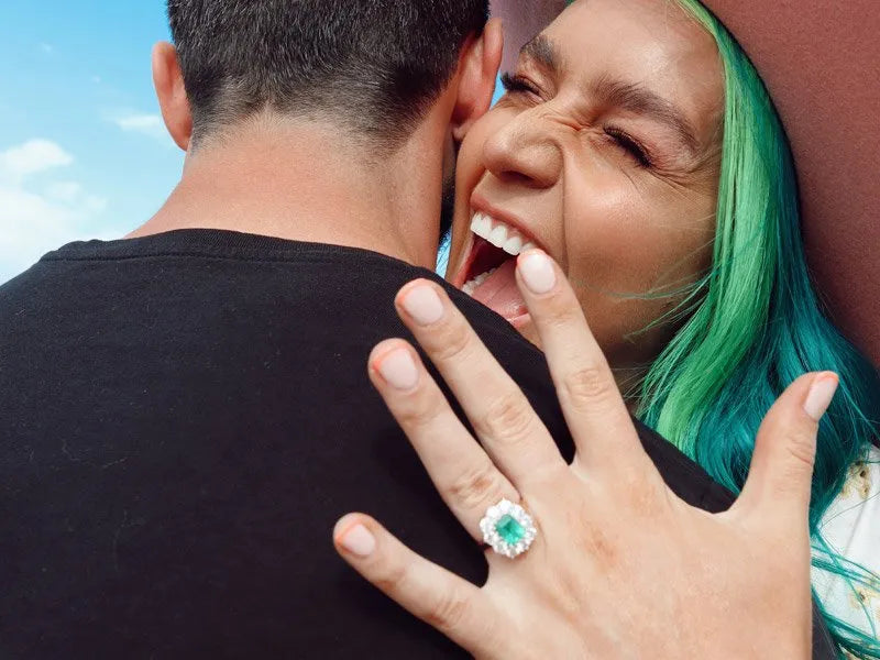 Lachlan Stuart and Amy Sheppard proposal with emerald and diamond cluster engagement ring