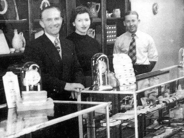 Hogans Family Jewellers staff serving behind counter in original store.