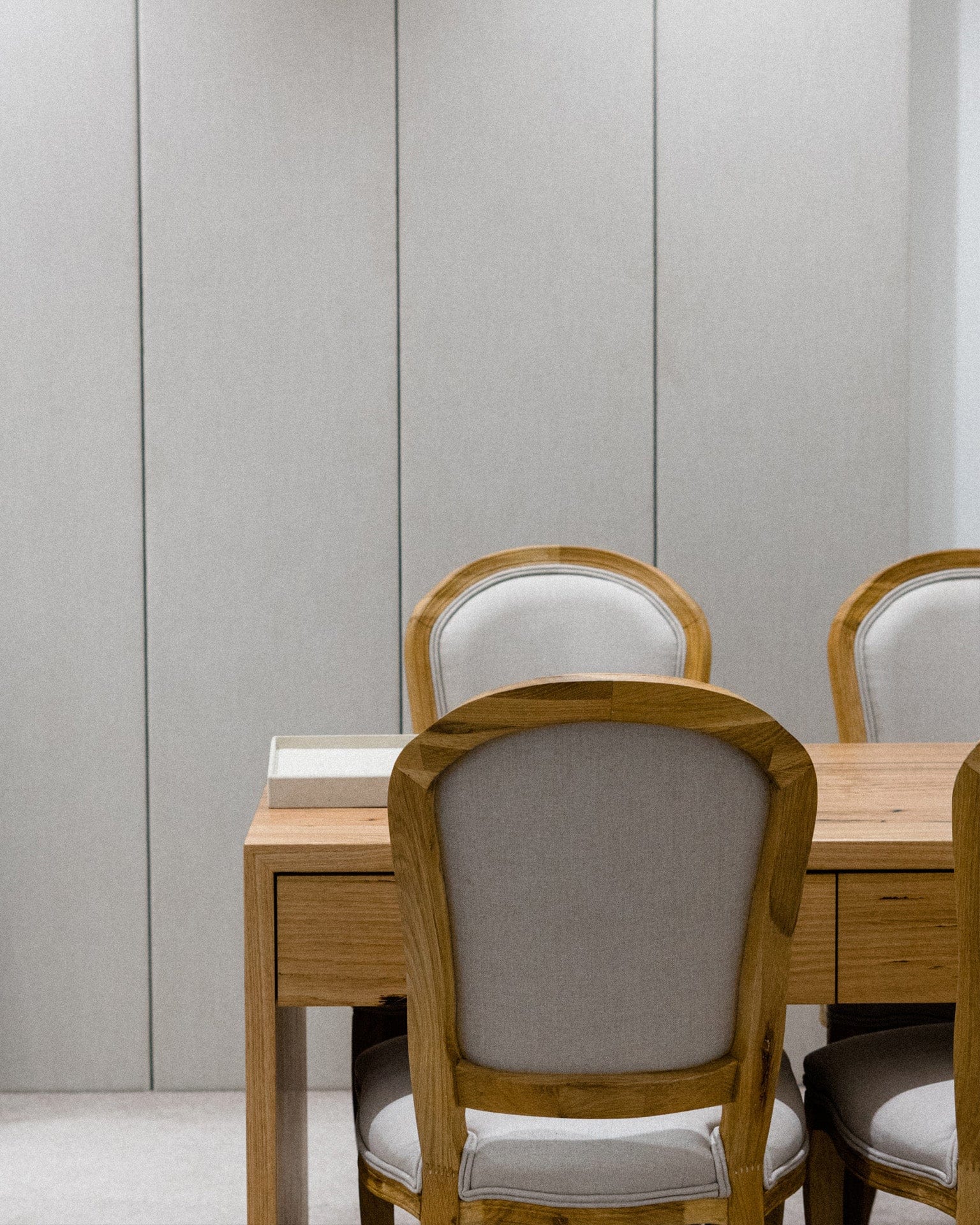 Hogans Family Jewellers private design consultation cubicle fitted out with wooden table and linen covered chairs.