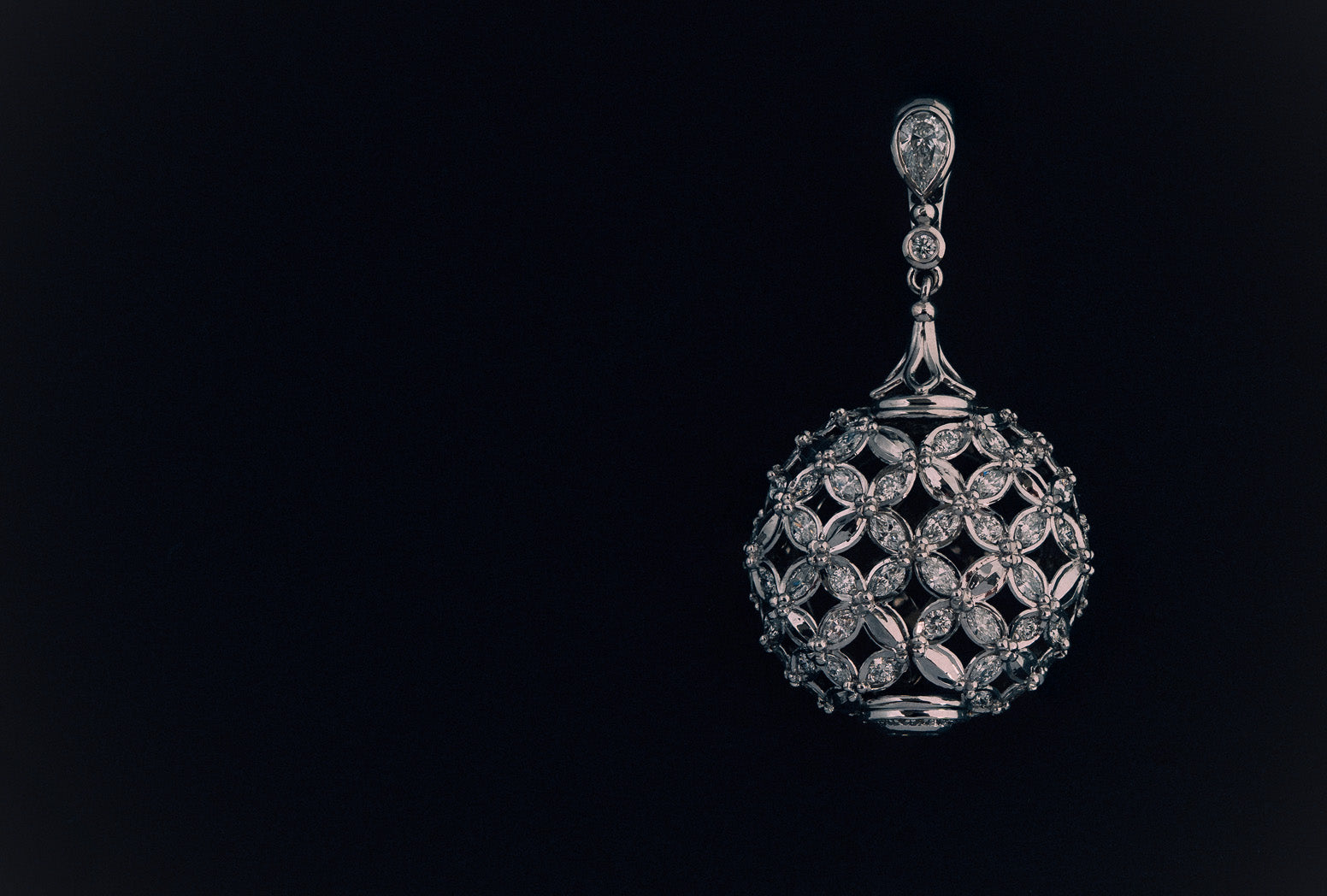 Enhancer pendant in white gold with marquise, oval, and round brilliant cut natural white diamonds.