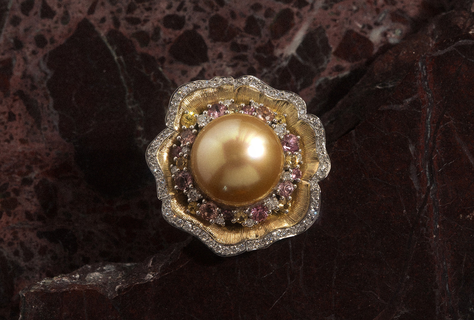 Yellow and white gold cluster dress ring with golden south sea pearl, multi coloured sapphires, and natural white round brilliant cut diamonds.