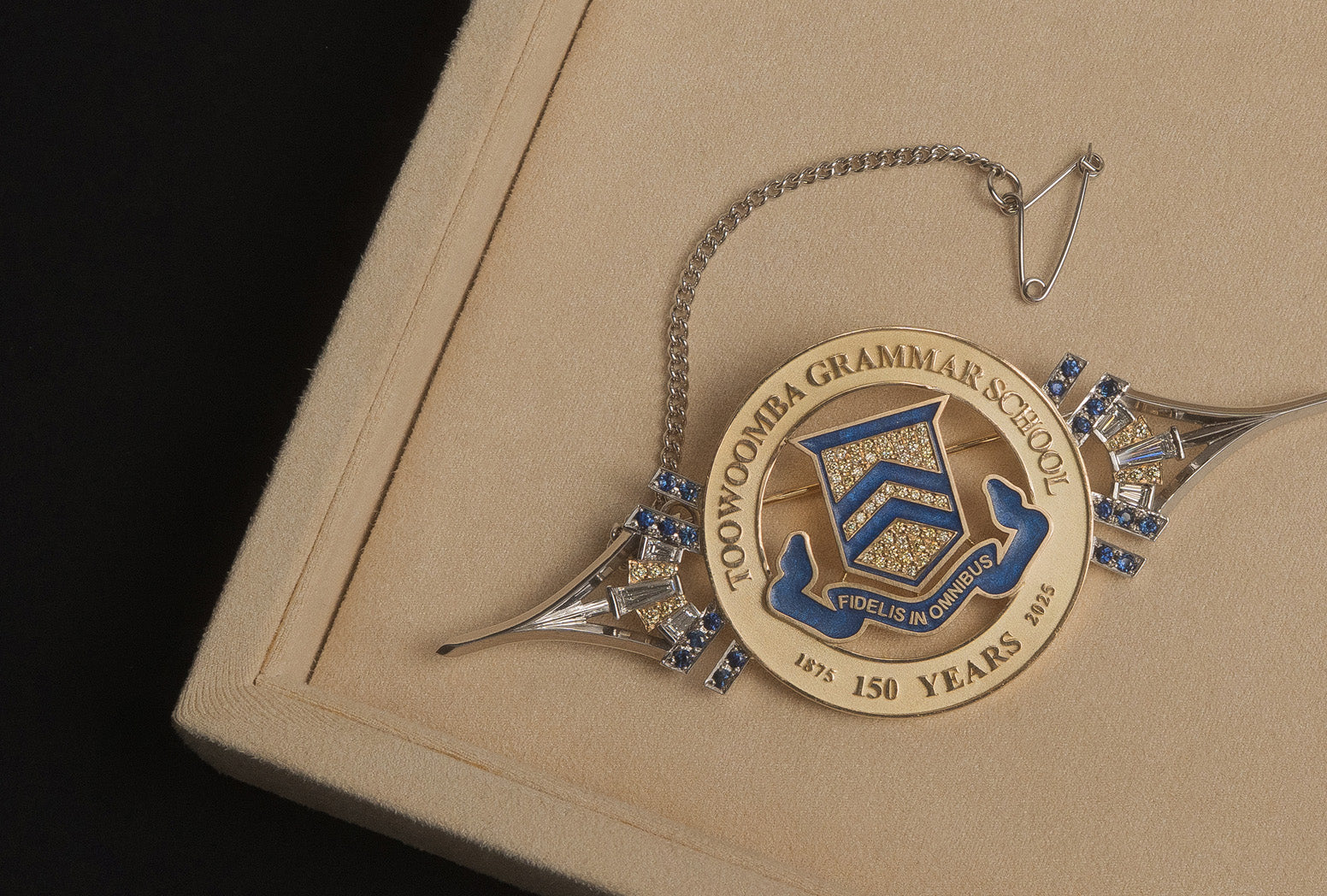 White gold Toowoomba Grammar School brooch with yellow and blue enamel.