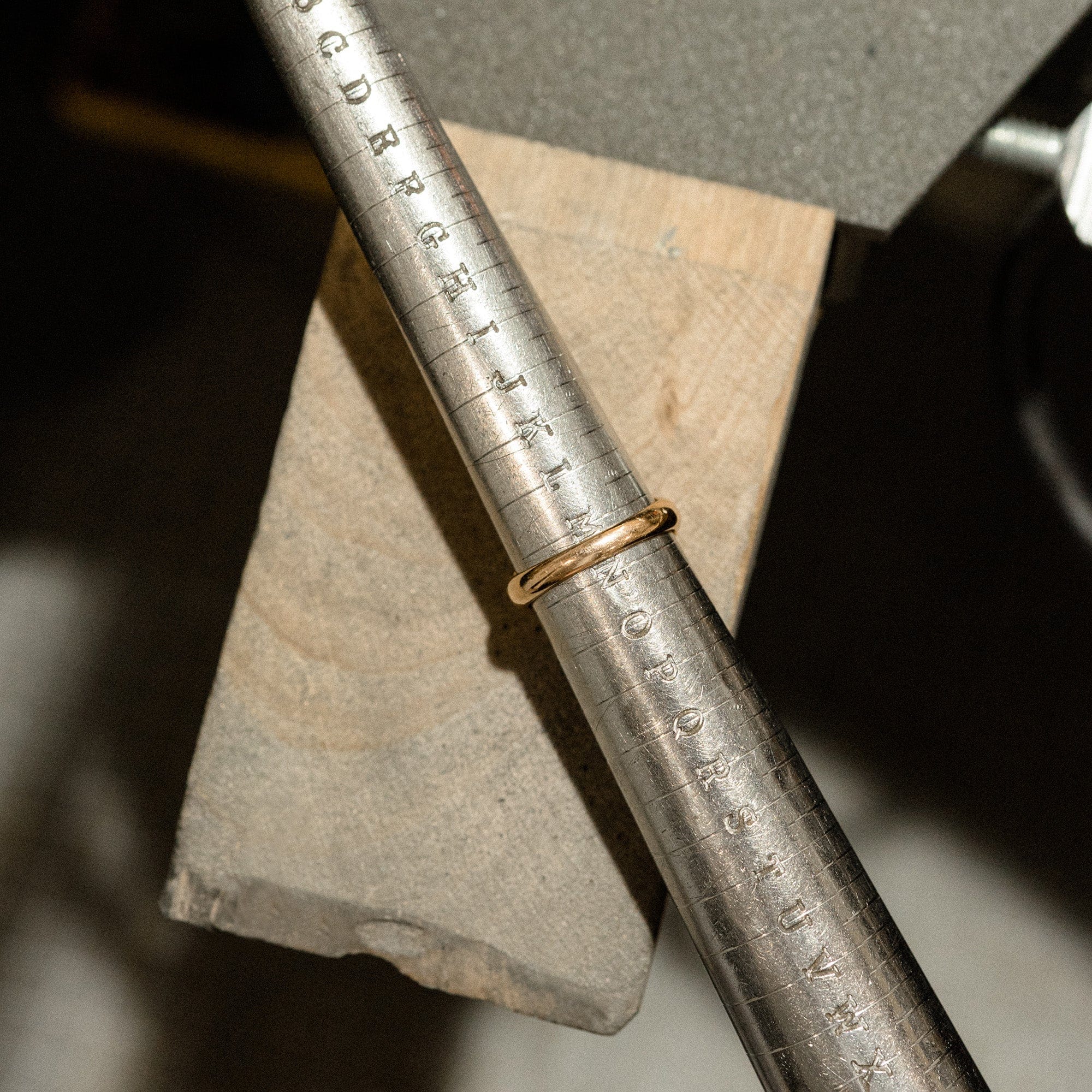 Plain gold ring on ring measuring stick.